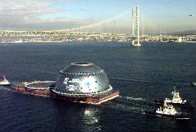 Hemispherical glass dome passes under Akashi Bridge